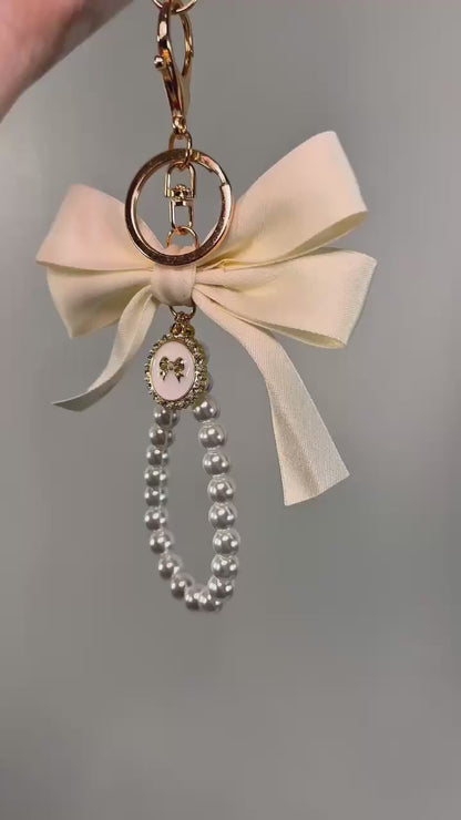 Cream Large Bow Pearl Finger Phone Strap